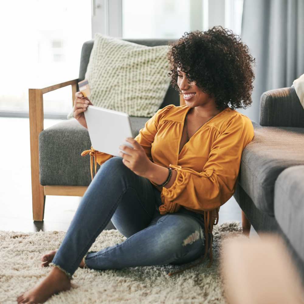 Resident making a payment in the apartment living room at Manchester Apartments in Manchester, Michigan