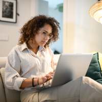 Woman using online resident portal at Parkwood Square in Arlington, Texas