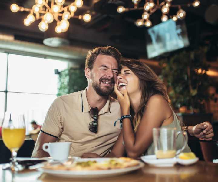 Resident couple enjoying their food at a restaurant near Lofts At Glenhaven in Winston Salem, North Carolina