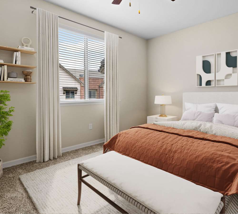 Spacious bedroom with natural light from a large window at The Parc at Greenwood Village in Greenwood Village, Colorado