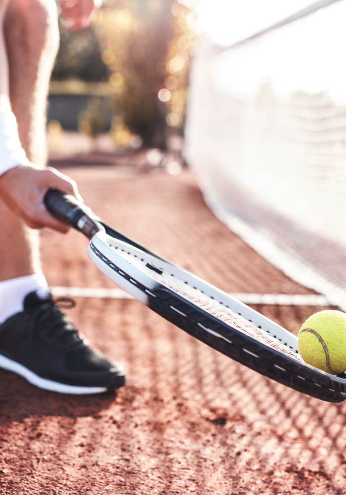 A resident playing tennis on the tennis court for residents at Brighton Park in Byron, Georgia