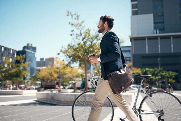 Resident man walking with his bike to work near 544 Southern Apartments in Mesa, Arizona