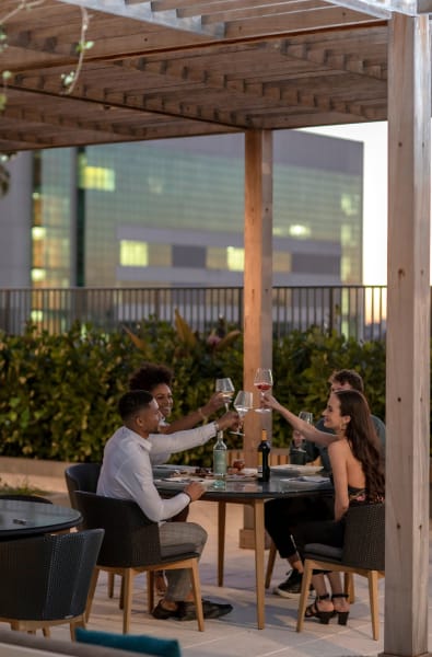 Residents enjoying the outdoor dining area at ParkLine Miami in Miami, Florida