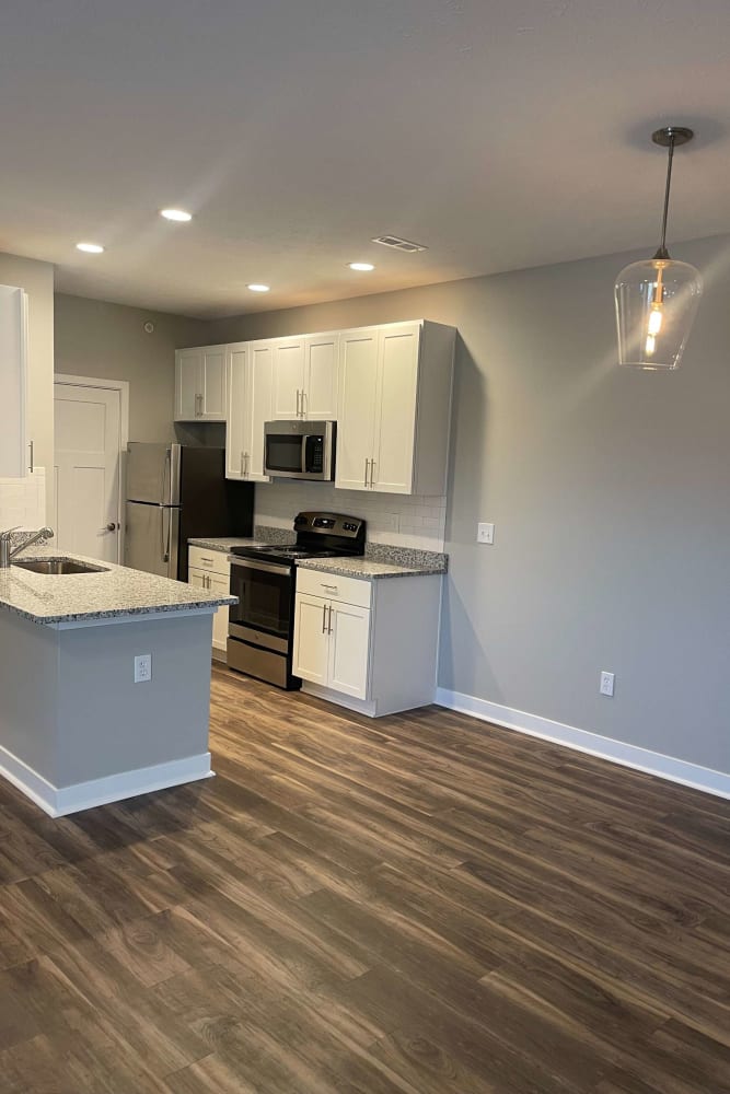 Kitchen with wood style flooring at Meridian Oaks Apartments in Greenwood, Indiana