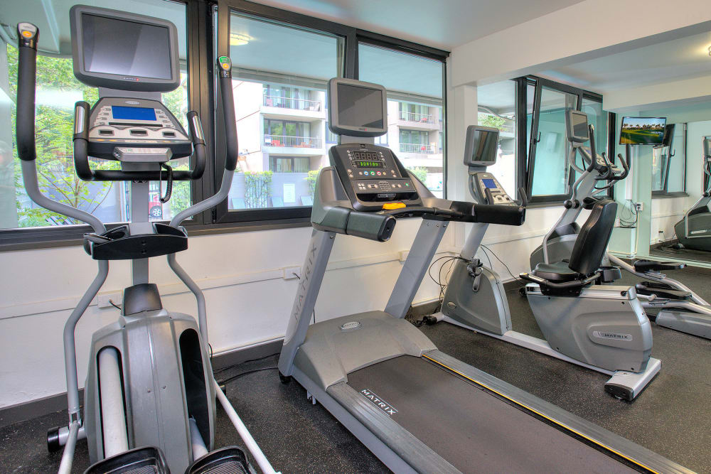 Well-equipped onsite fitness center at Harrison Tower in Portland, Oregon