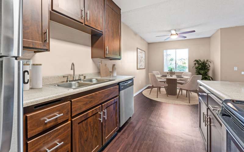 Renovated kitchen with brown cabinets at Shadow Ridge Apartments in Oceanside, California