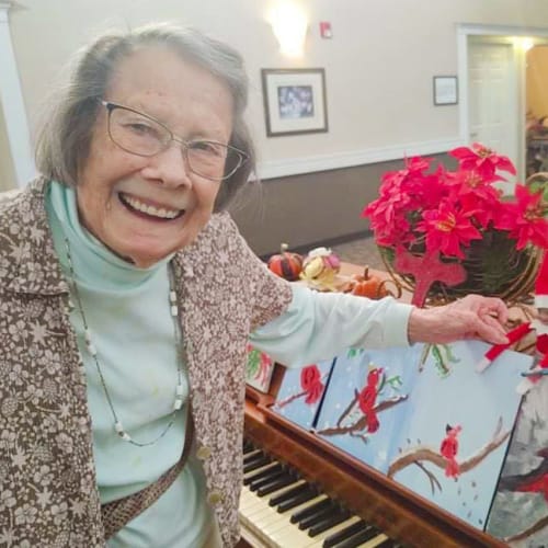 Smiling resident with piano Canoe Brook Assisted Living in Broken Arrow, Oklahoma