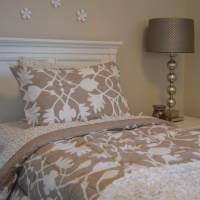 Bedroom with cozy bed and night lamp at The Warrick in Nashville, Tennessee