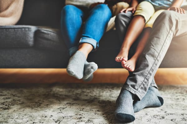 Family cozied up on the couch of their new home at East Broad Plaza in Columbus, Ohio