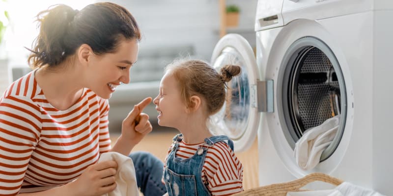 a mother and daughter doing laundry at Dahlgren Townhomes in Dahlgren, Virginia