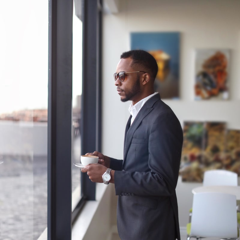 Resident admiring the ocean view from his live/work unit at Portside Ventura Harbor in Ventura, California