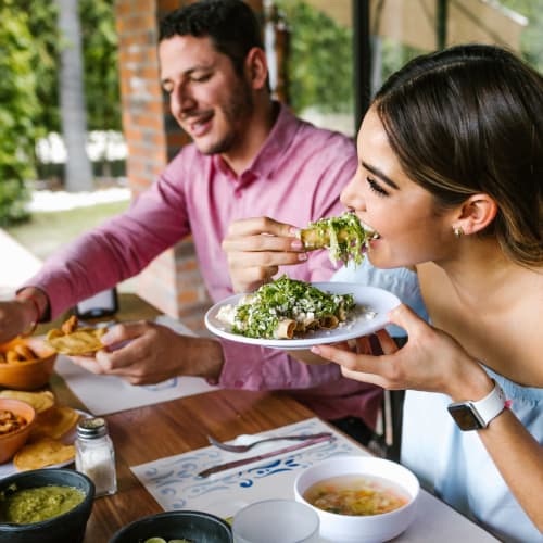Couple eating lunch on the patio at a Mexican restaurant near Villagio Luxury Apartments in Sacramento, California