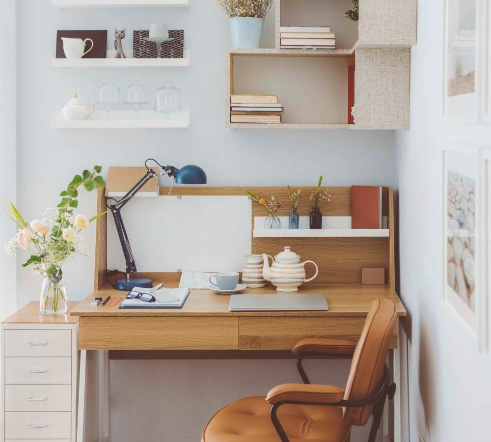 Wooden desk with chair and decorative items at Avia Lofts at Maple Road in Amherst, New York