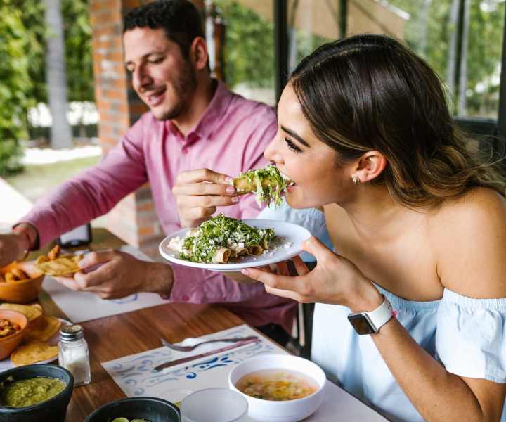 Resident couple having food at restaurant near Oakwood Condos Bedford in Bedford, Texas 