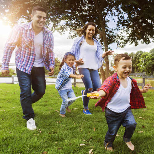 A happy nuclear family having a good time in a park near Hawthorn at Oakhurst in Aurora, Illinois