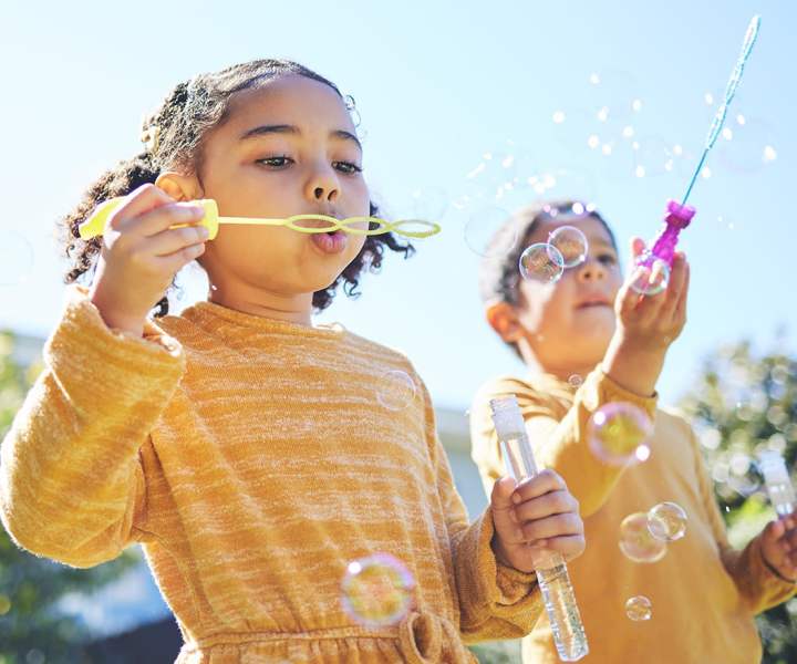 Children playing with bubbles outside at Addison Grove in Avon Park, Florida