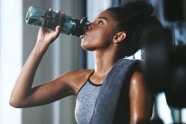A resident drinking water during a workout in the fitness center at Vue North Apartments in Rochester, Minnesota