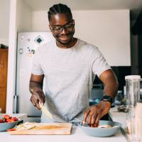 Resident man chopping vegetables at Warrick Trail Apartments in Newburgh, Indiana