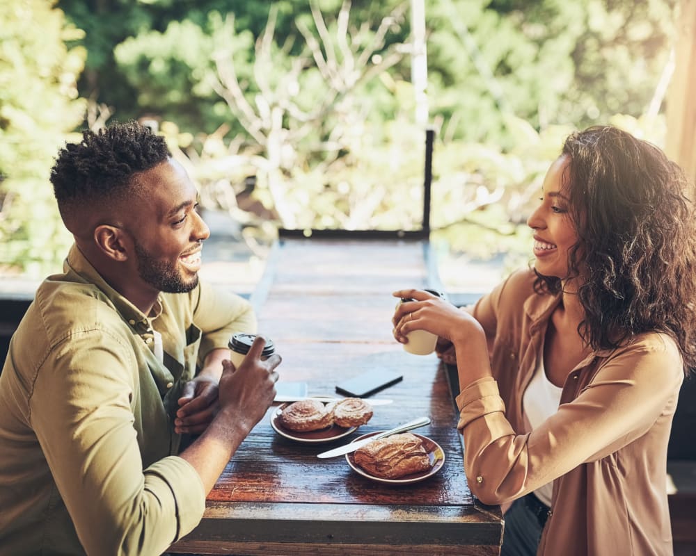 Residents drinking coffee and eating pastries near Home Terrace in San Diego, California