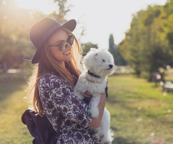 A resident holding a dog outside at Naval Amphibious Base in San Diego, California