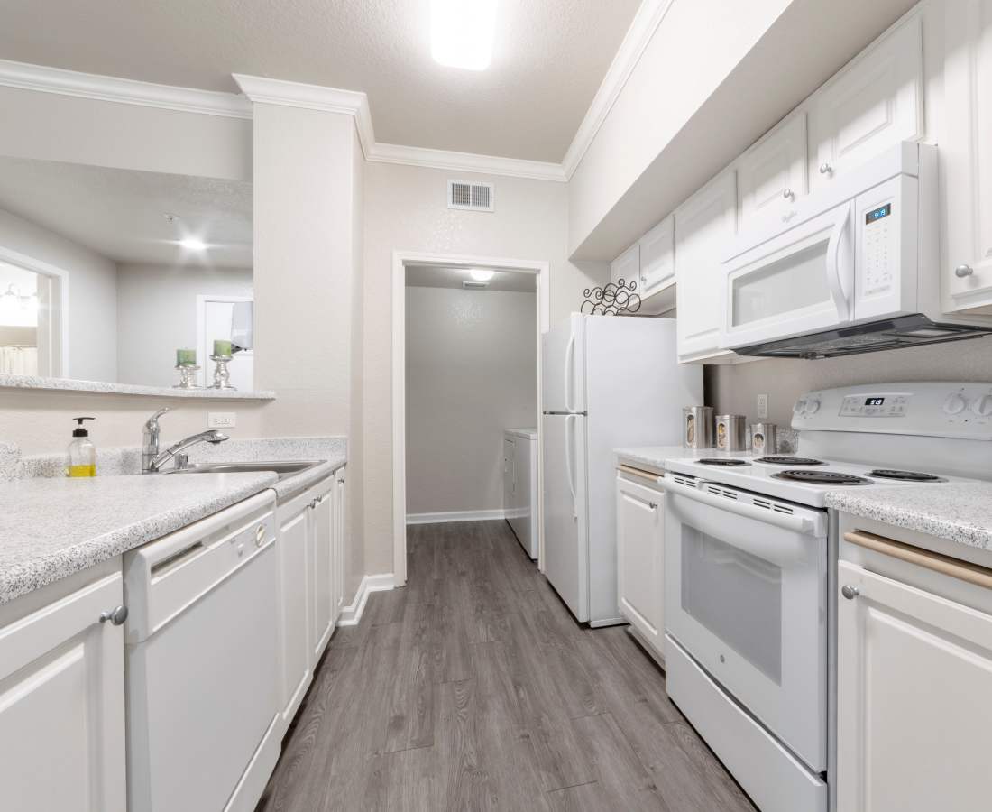 Kitchen with wood-style flooring at Oak Brook Apartments in Rancho Cordova, California