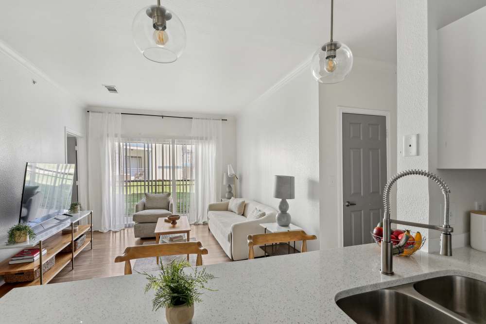 Kitchen with a granite countertop, range, oven, and dining area at Legends Lake Creek in Austin, Texas