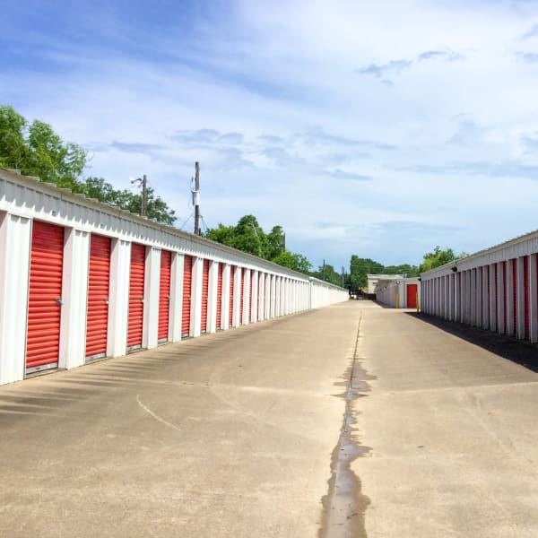 Exterior units with red doors at StorQuest Self Storage in Friendswood, Texas
