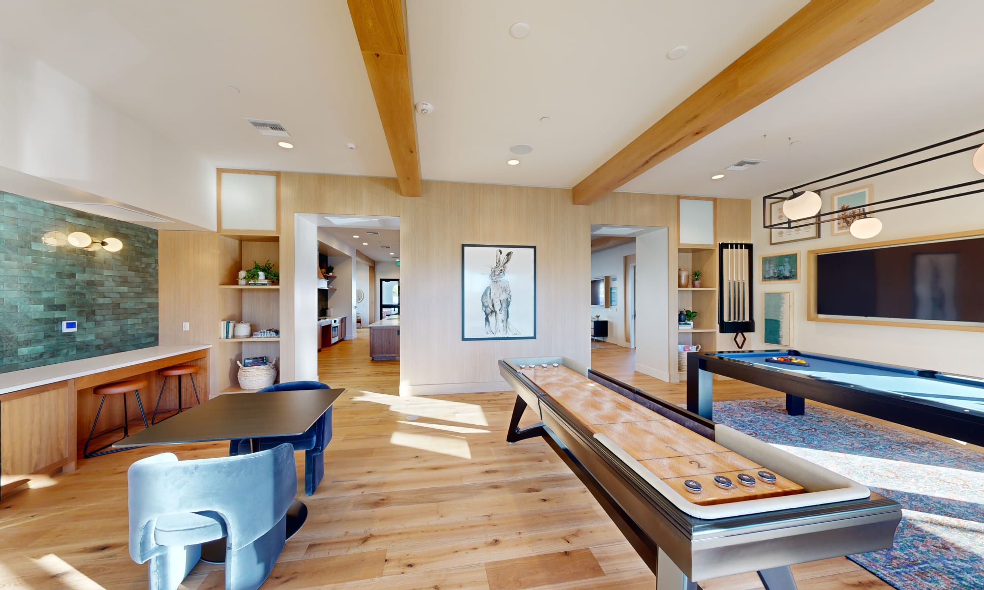 Shuffle board and pool table in the resident lounge at The Villas at Anacapa Canyon in Camarillo, California
