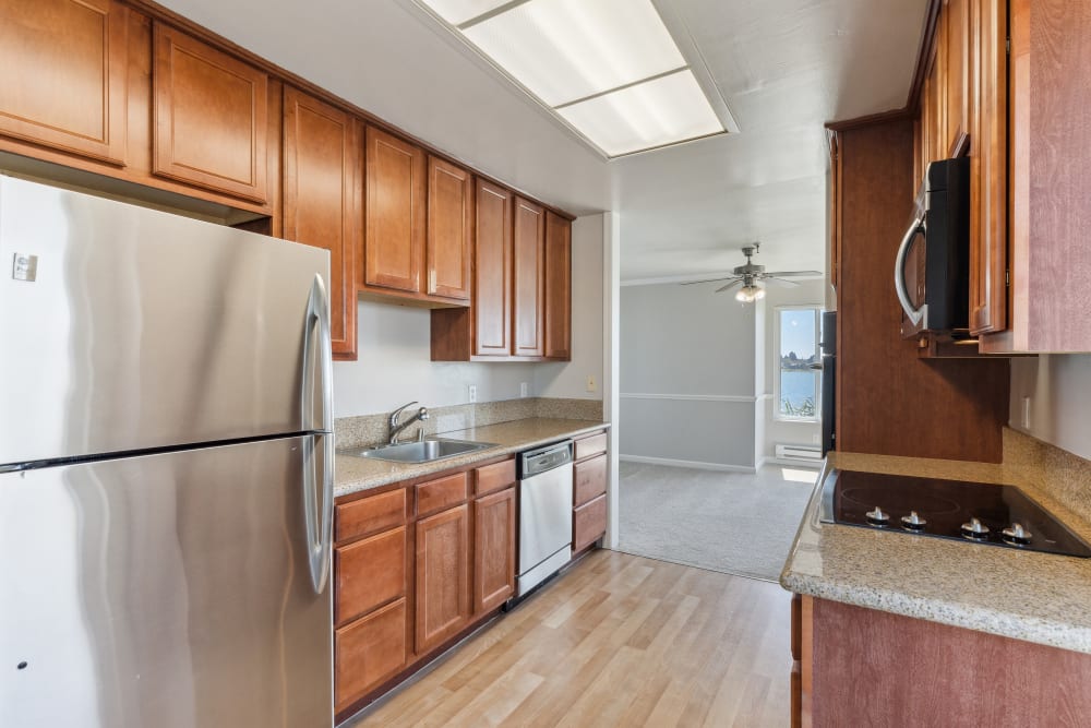 Luxury apartment kitchen with stainless-steel appliances at Tower Apartment Homes in Alameda, California