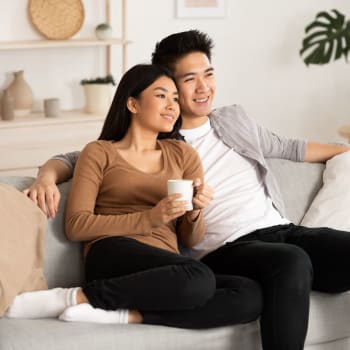 Couple relaxing at home at Adobe Lake Apartments in Concord, California