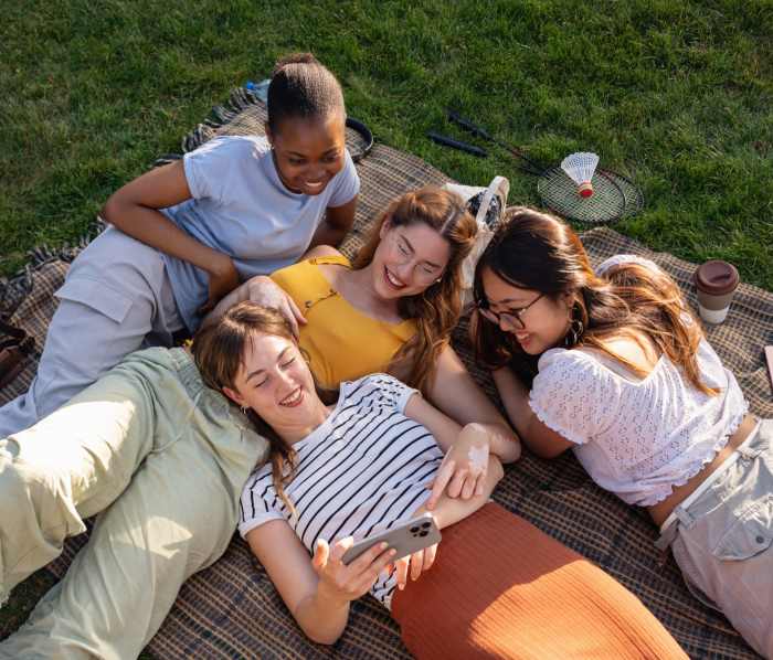 Picnic area with residents relaxing on blanket at Sycamore at Scottsdale in Scottsdale, Arizona