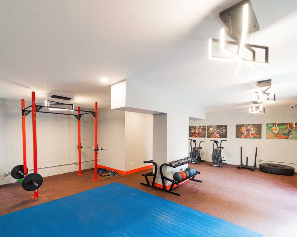 Fitness center with modern lighting at Encore 99 in East Haven, Connecticut