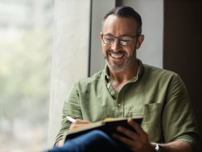 Resident reads a book in his apartment at Marina Breeze in San Leandro, California