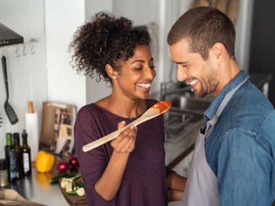 Resident couple cooking in their new kitchen at Lakeshore Apartments in Concord, California