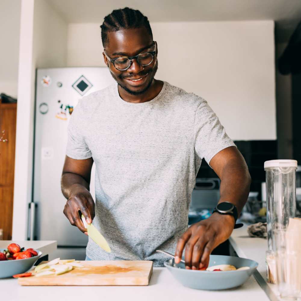 Resident cooking in his apartment kitchen at Mapleview Apartments in Maple Rapids, Michigan