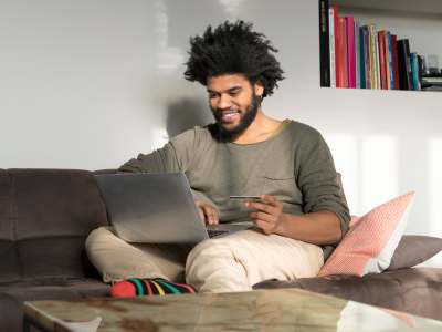 Resident on his laptop at home at St. Michael's Apartments in Riverside, California