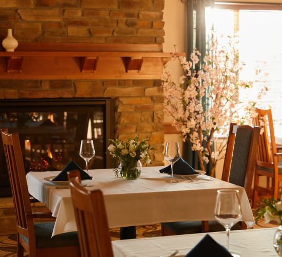 Dining room with cotton bramble decoration and a fireplace at Amira Choice Forest Lake in Forest Lake, Minnesota. 