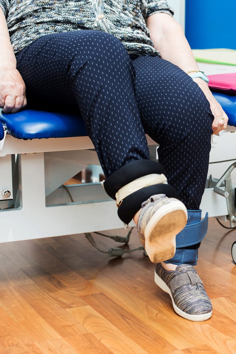 Resident with ankle weights at Maple Ridge Care Center in Spooner, Wisconsin