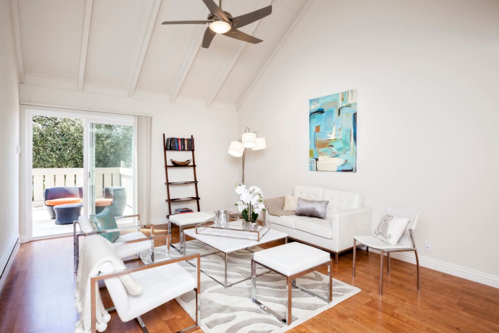 Living room with wood-style flooring at Brookdale Apartments in San Jose, California