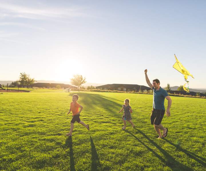 Family enjoying in a park near Beacon Place at Kentlands in Gaithersburg, Maryland