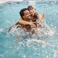 Residents enjoying swimming in the pool at Woodchase Apartments in San Leandro, California