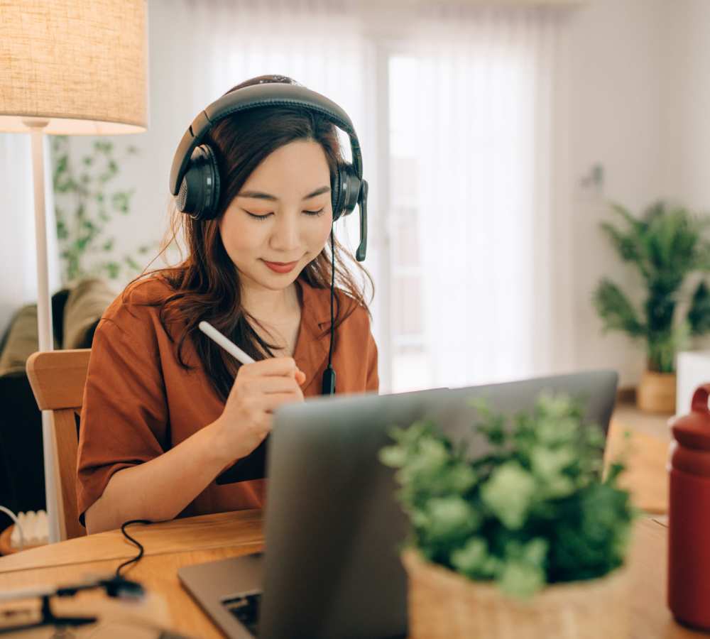 Resident working on her laptop in her student apartment at Titan Court in Eugene, Oregon