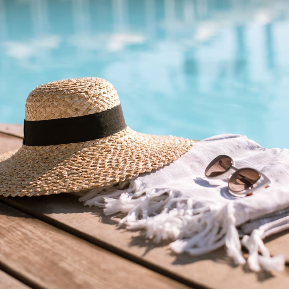 Hat and towel by the pool at Villas At Villaggio in Modesto, California
