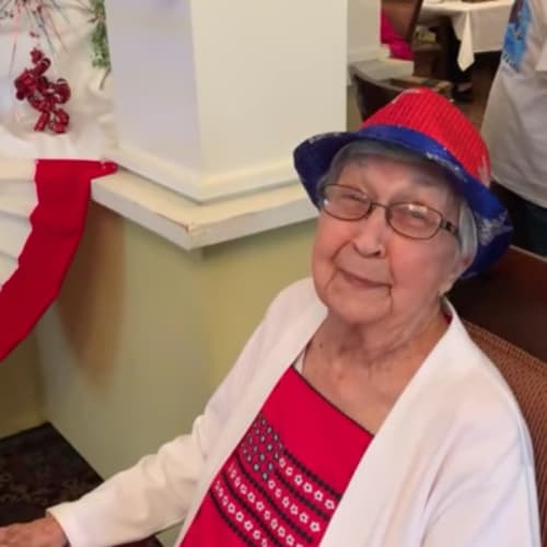 Smiling resident wearing a hat at a party at Mathison Retirement Community in Panama City, Florida