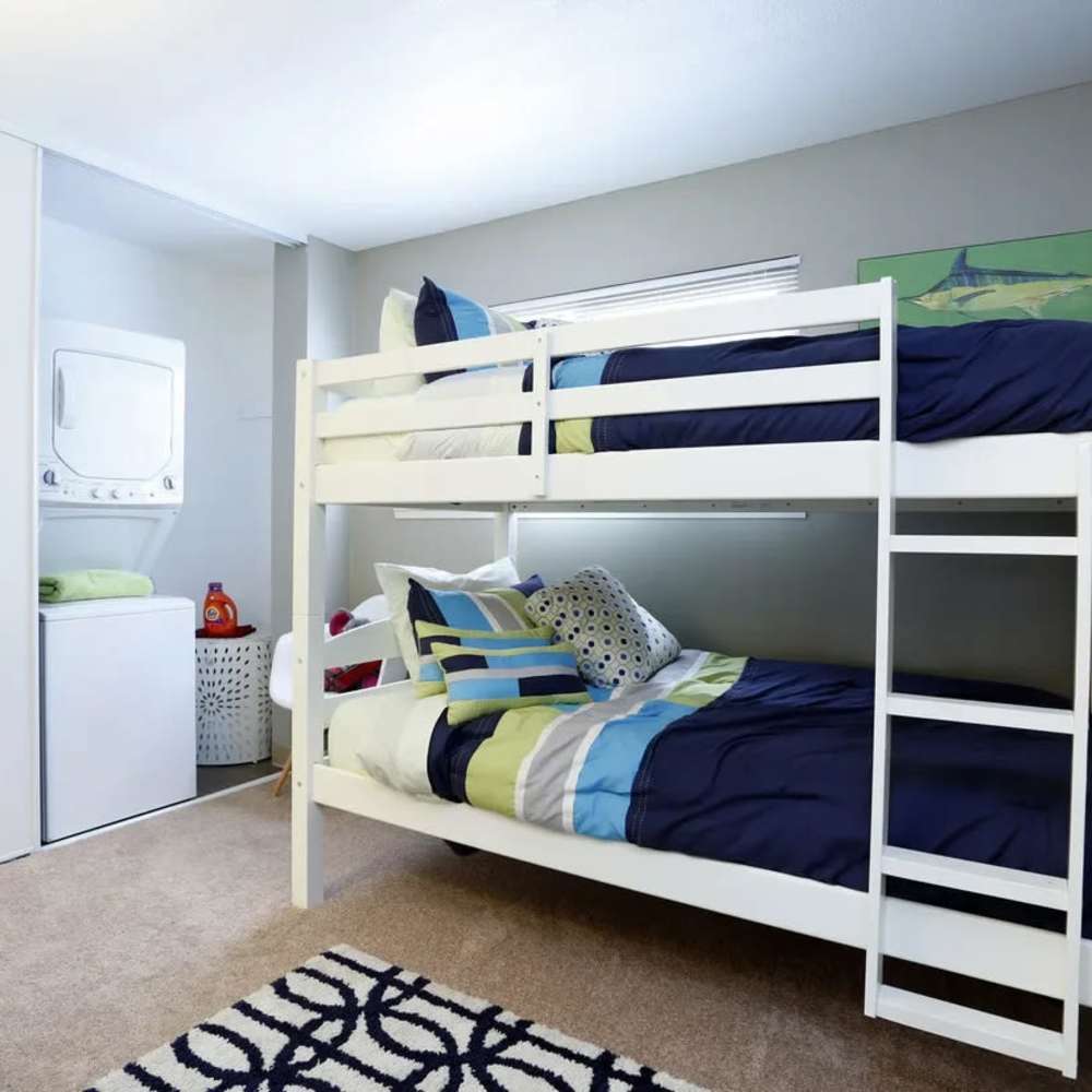 Children bedroom with bunkbed and stackable laundry unit at Renton Sage in Renton, Washington