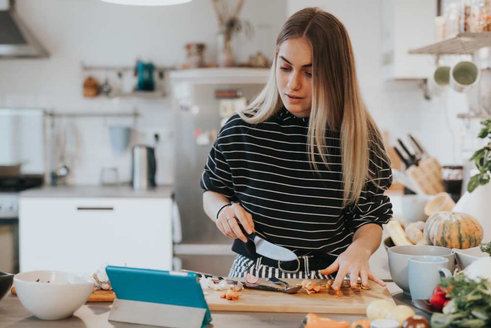 Resident woman working in kitchen at Cypress Point Apartments in Shawnee, Oklahoma