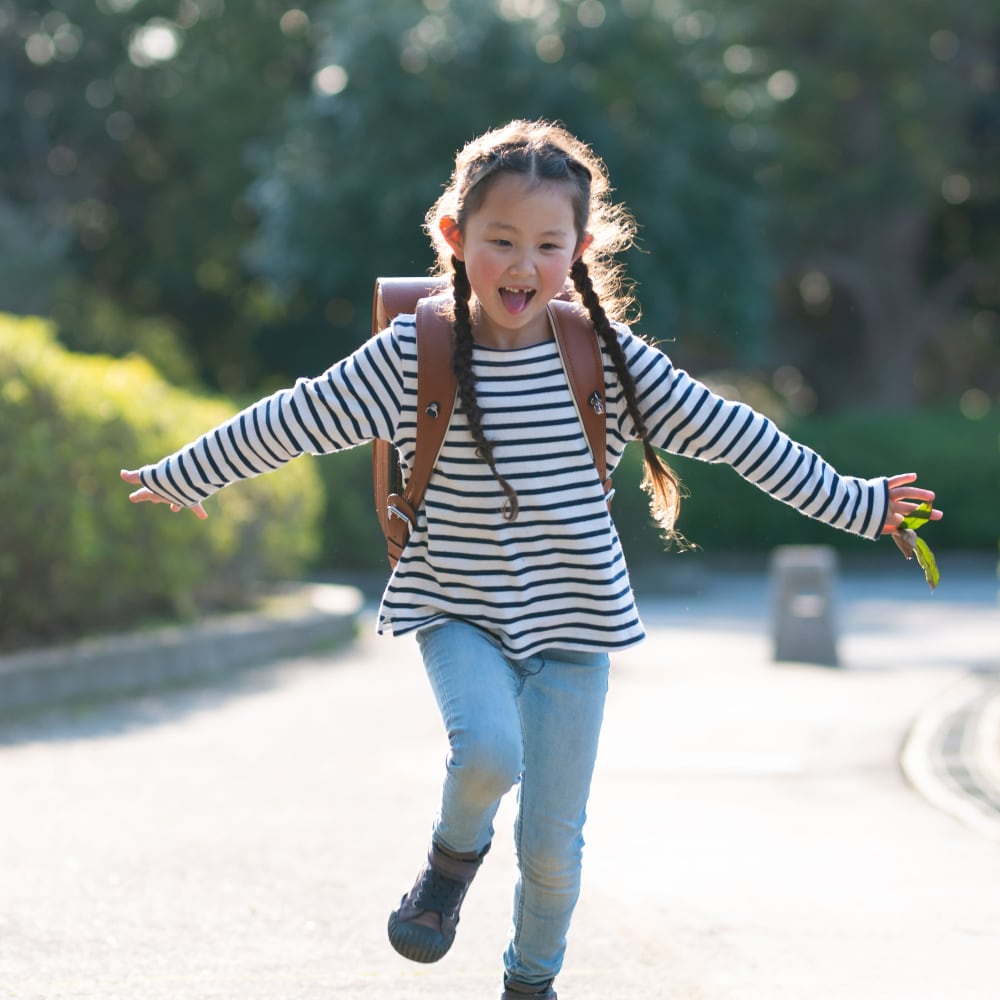 Young resident walking home from school to Montgomery Woods Townhomes in Harleysville, Pennsylvania