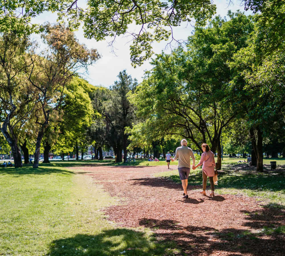 Resident couples walking in a lush green park near The Huntington in Morgan Hill, California