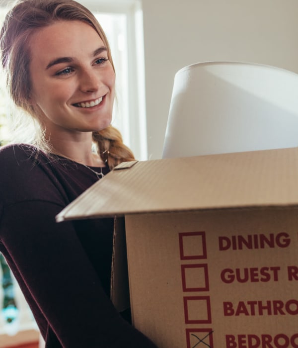 A customer holding a packed box at A-AAAKey - Broadway in San Antonio, Texas