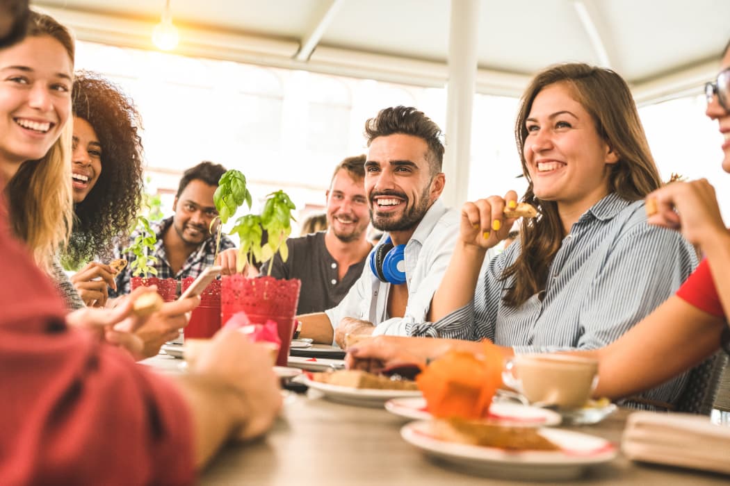 Friends sharing a meal together at Aspire at 610 in Houston, TX